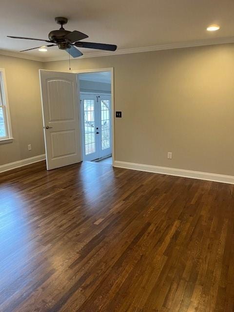 unfurnished room featuring ornamental molding, dark wood-style flooring, and a wealth of natural light