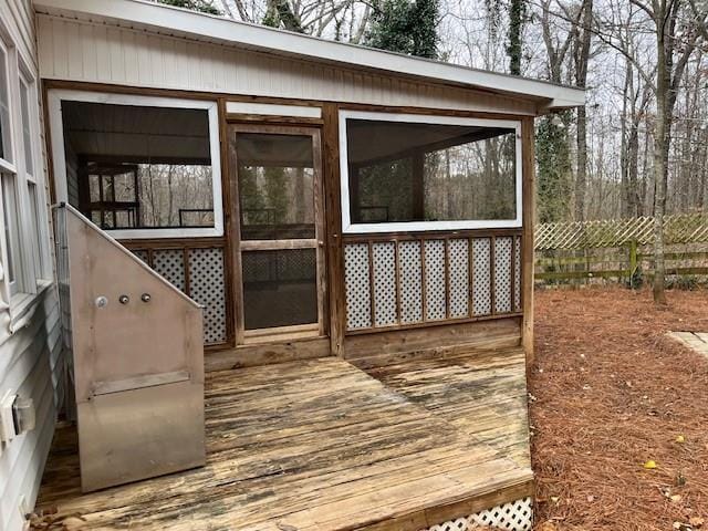 wooden terrace featuring fence and a sunroom