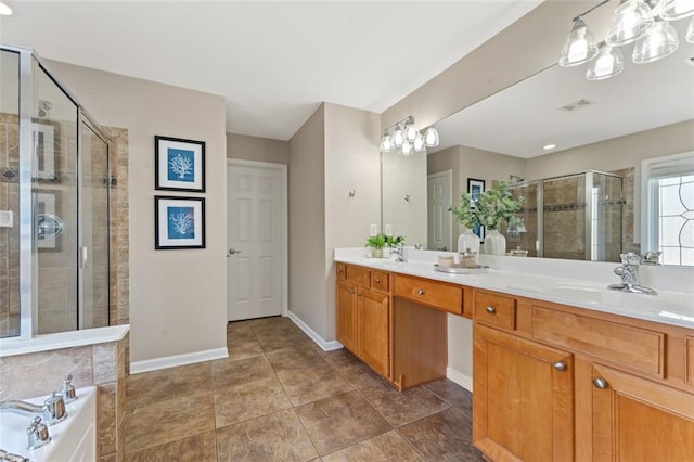 bathroom with visible vents, a sink, a shower stall, double vanity, and baseboards