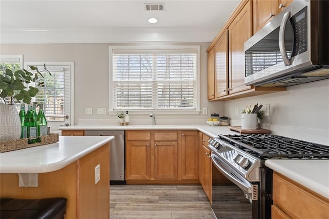 kitchen with visible vents, appliances with stainless steel finishes, and light countertops