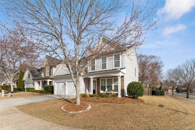 view of front facade featuring a garage, a front lawn, a porch, and driveway