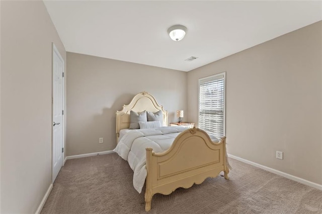 carpeted bedroom with visible vents and baseboards