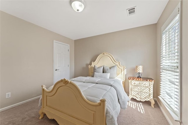 bedroom featuring visible vents, carpet flooring, and baseboards