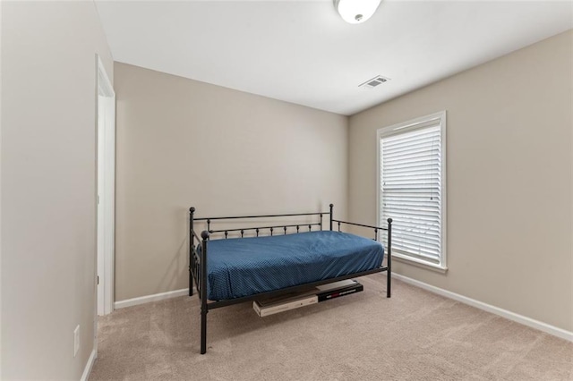 carpeted bedroom featuring visible vents and baseboards