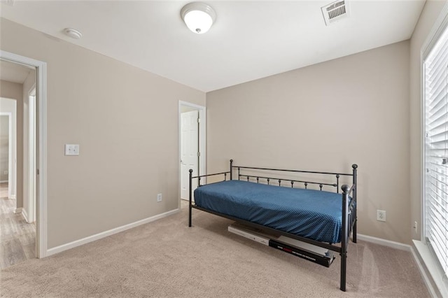 bedroom featuring visible vents, multiple windows, and carpet