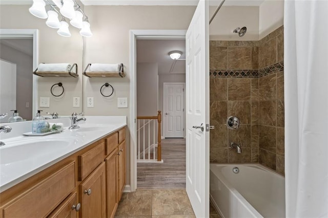 full bath featuring a sink, shower / tub combo with curtain, and double vanity