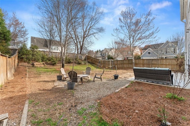 view of yard featuring a patio, a fire pit, and a fenced backyard