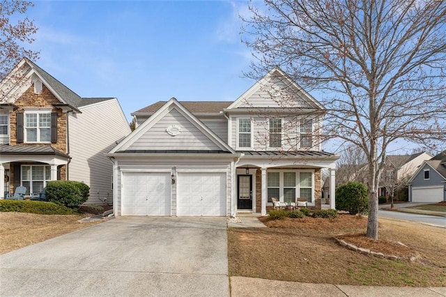 view of front of home featuring a standing seam roof, covered porch, concrete driveway, and a garage