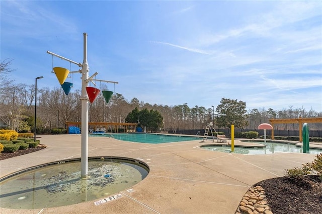 community pool with a community hot tub and fence