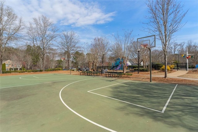 view of sport court featuring community basketball court, playground community, and fence