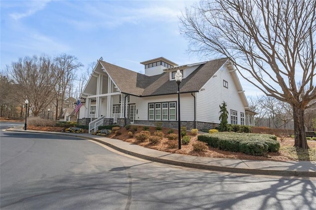 view of front of home with a shingled roof