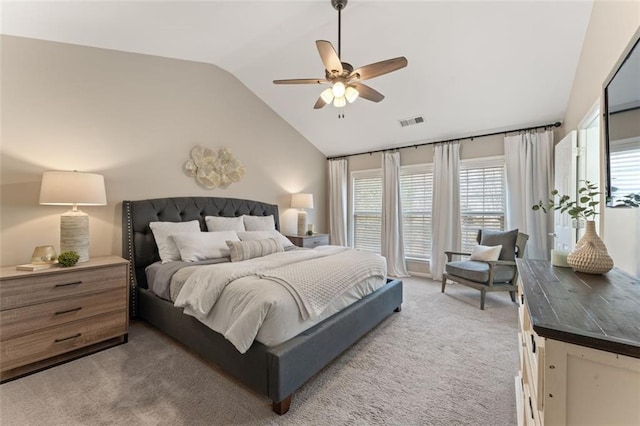 bedroom with ceiling fan, lofted ceiling, visible vents, and light carpet