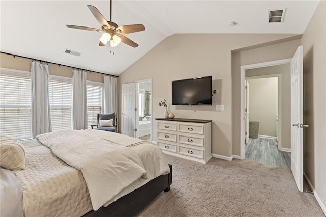 bedroom with visible vents, light carpet, baseboards, and vaulted ceiling