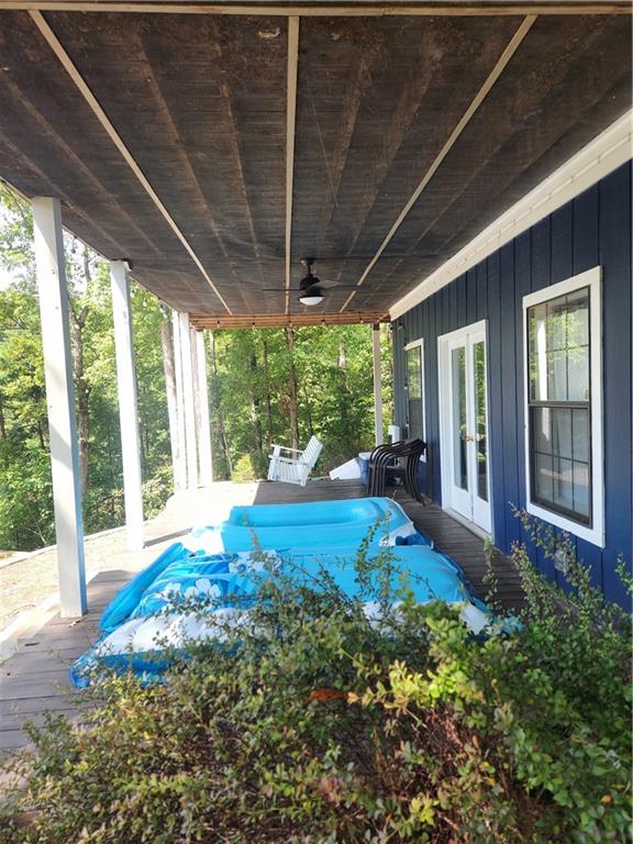 view of yard with french doors and ceiling fan