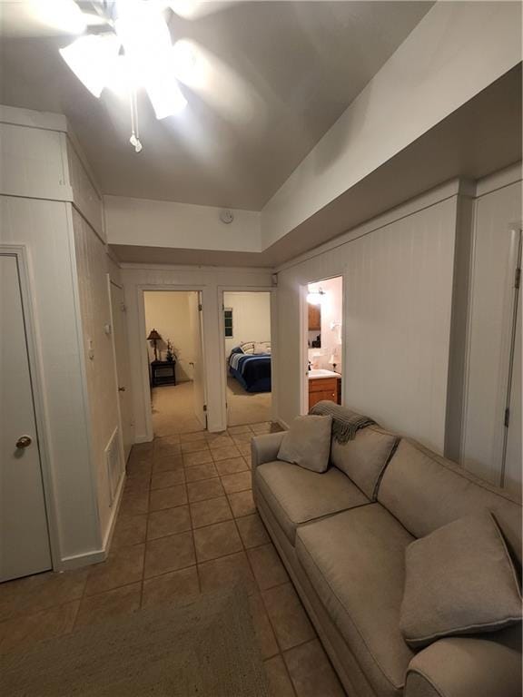 tiled living room with ceiling fan