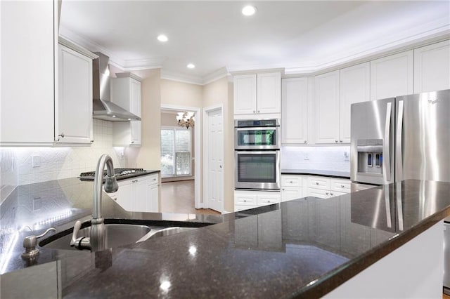 4957 Day Lily Way NW, Acworth, GA 30102 - kitchen with wall chimney range hood, stainless steel appliances, backsplash, crown molding, and dark stone countertops