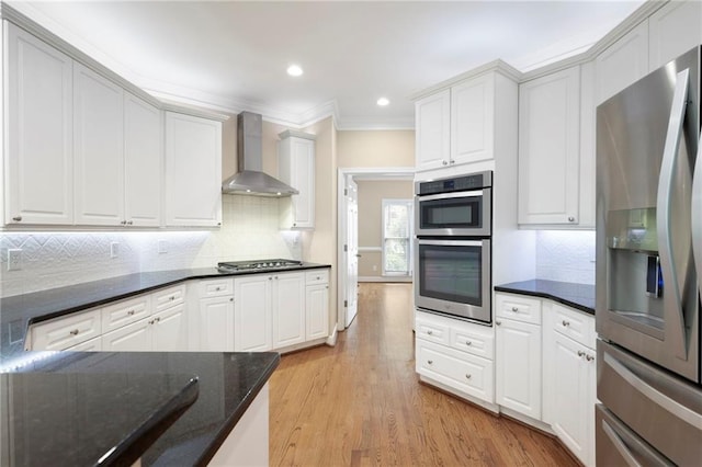 4957 Day Lily Way NW, Acworth, GA 30102 - kitchen with appliances with stainless steel finishes, wall chimney range hood, crown molding, tasteful backsplash, and light wood finished floors