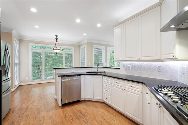 4957 Day Lily Way NW, Acworth, GA 30102 - kitchen with appliances with stainless steel finishes, a sink, wall chimney range hood, ornamental molding, and a peninsula