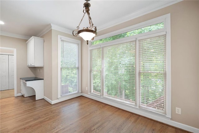 4957 Day Lily Way NW, Acworth, GA 30102 - unfurnished dining area with crown molding, baseboards, plenty of natural light, and light wood-type flooring