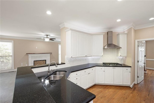 4957 Day Lily Way NW, Acworth, GA 30102 - kitchen with wall chimney range hood, a sink, stainless steel gas cooktop, ceiling fan, and tasteful backsplash