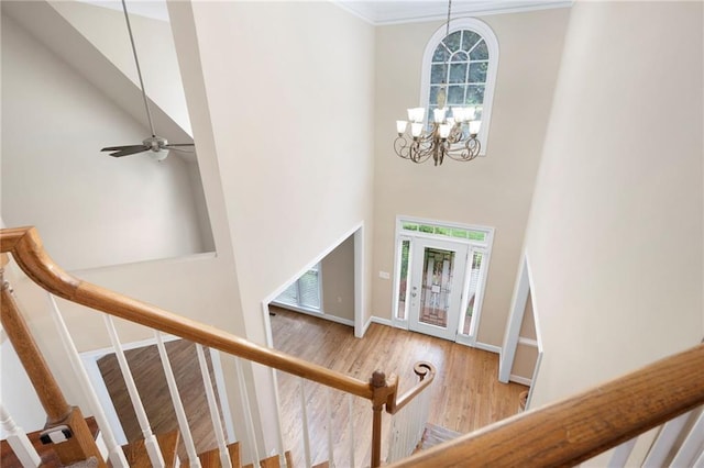 4957 Day Lily Way NW, Acworth, GA 30102 - foyer entrance featuring a high ceiling, stairs, wood finished floors, a chandelier, and ornamental molding