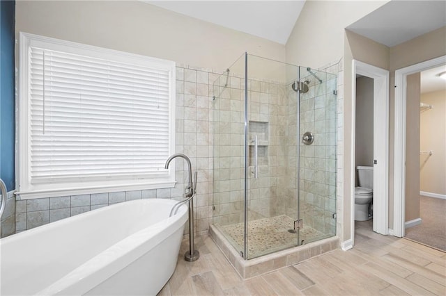 4957 Day Lily Way NW, Acworth, GA 30102 - bathroom featuring a stall shower, wood finished floors, a soaking tub, toilet, and vaulted ceiling