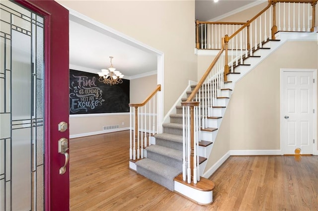 4957 Day Lily Way NW, Acworth, GA 30102 - entryway with wood finished floors, stairs, a chandelier, and ornamental molding