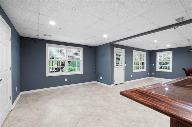 4957 Day Lily Way NW, Acworth, GA 30102 - empty room with a paneled ceiling, baseboards, healthy amount of natural light, and tile patterned flooring