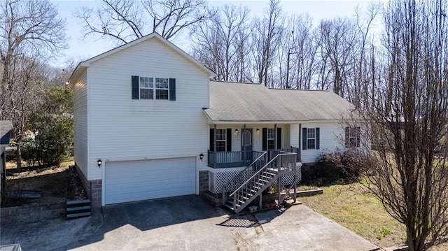 view of front of property with a garage, covered porch, driveway, and stairway