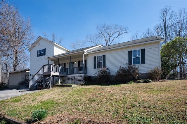 view of front of house with a porch, a front lawn, and stairs