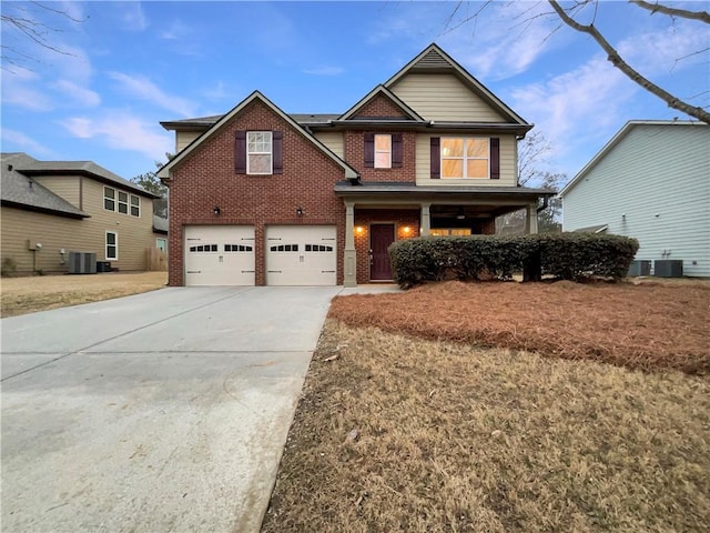 craftsman house with a garage and cooling unit