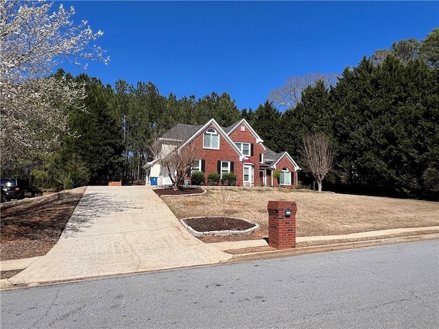 traditional-style house with concrete driveway