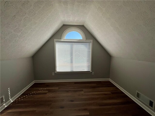 full bath featuring double vanity, tile patterned flooring, walk in shower, and a sink