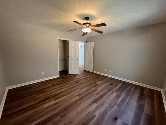 additional living space featuring a textured ceiling, baseboards, vaulted ceiling, and dark wood-type flooring