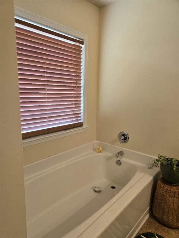 bathroom featuring a bath and tile patterned floors