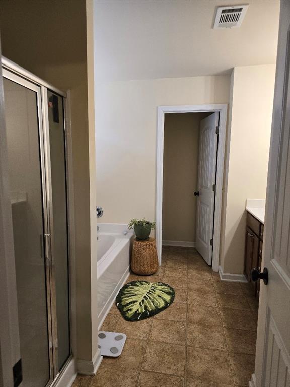 bathroom with vanity and independent shower and bath