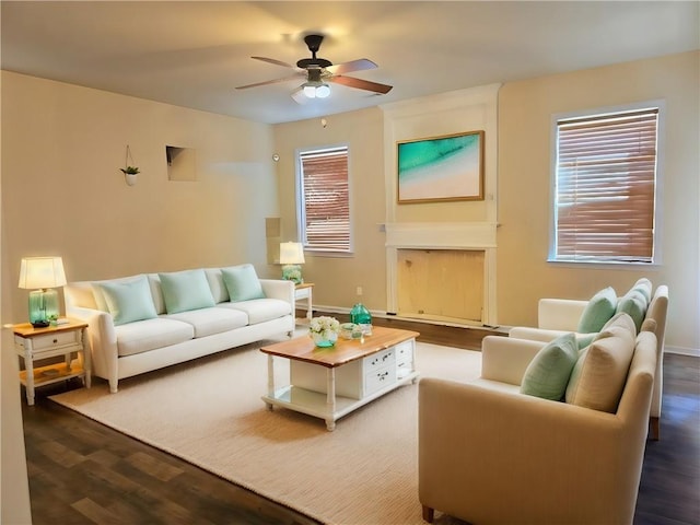 living room featuring ceiling fan and dark wood-type flooring