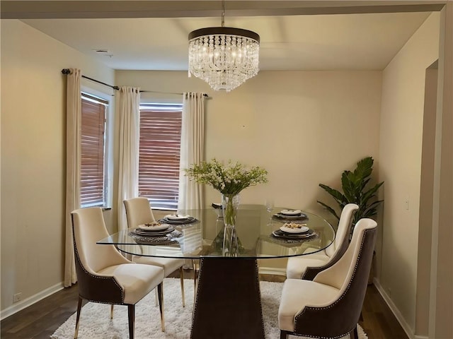 dining area with an inviting chandelier and dark hardwood / wood-style flooring