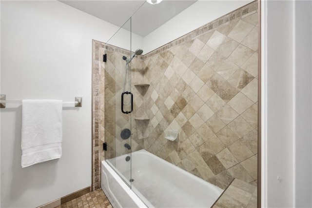 full bathroom with baseboards and shower / bath combination with glass door