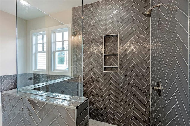 bathroom featuring a tile shower