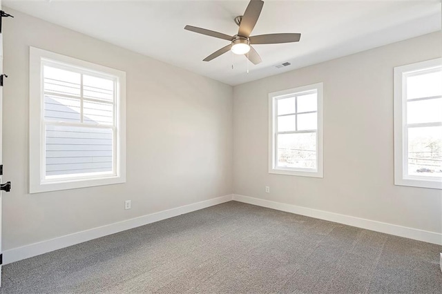 carpeted spare room with ceiling fan