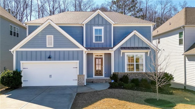 view of front facade with board and batten siding, concrete driveway, and roof with shingles