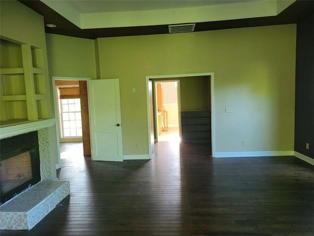 164 Mcclain Cir, Macon, GA 31216 - unfurnished living room with dark wood-style floors and a fireplace with raised hearth