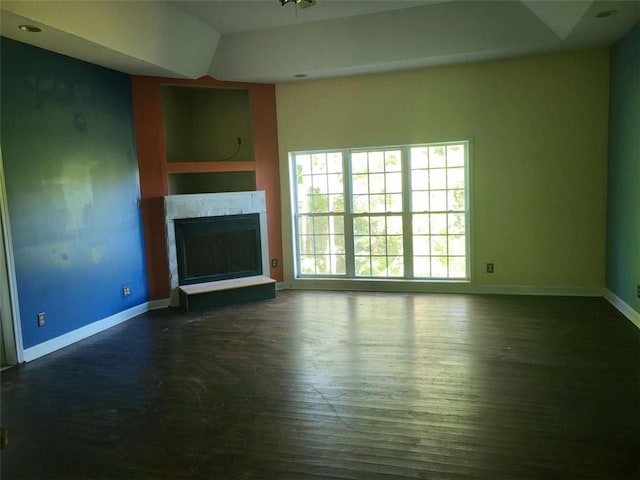 164 Mcclain Cir, Macon, GA 31216 - unfurnished living room with dark wood finished floors and a fireplace with raised hearth