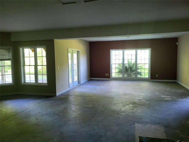 164 Mcclain Cir, Macon, GA 31216 - spare room featuring unfinished concrete flooring and healthy amount of natural light