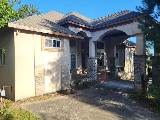 164 Mcclain Cir, Macon, GA 31216 - view of front facade featuring stucco siding, roof with shingles, and stone siding