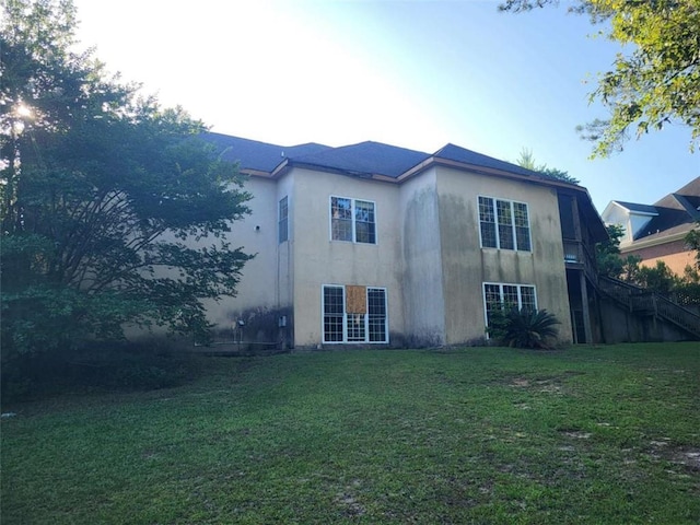 164 Mcclain Cir, Macon, GA 31216 - back of property featuring stairway, a lawn, and stucco siding