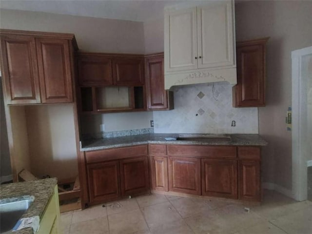 164 Mcclain Cir, Macon, GA 31216 - kitchen featuring decorative backsplash, stone counters, light tile patterned flooring, and stovetop