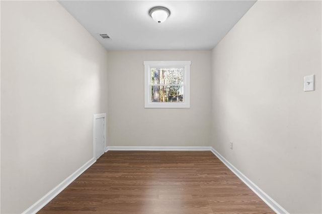 spare room featuring wood-type flooring