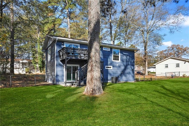 back of property featuring a yard and a wooden deck